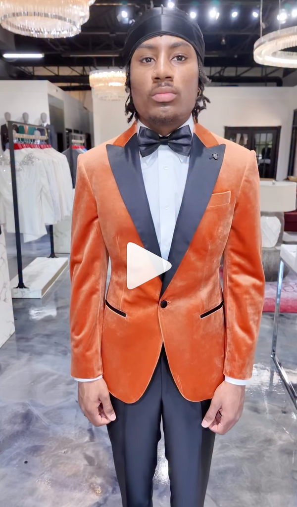 Orange velvet suit with black lapels styled in a modern store setting