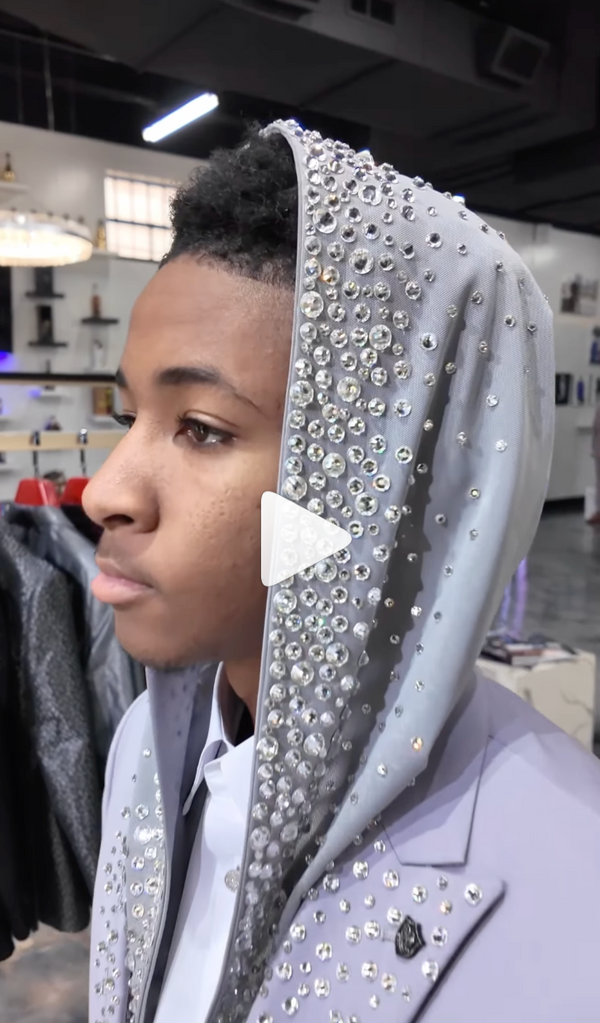 Gray suit with rhinestone hood in a chic store with modern display setting