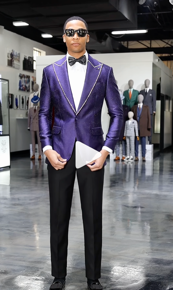 Man in purple tuxedo with white shirt and black bow tie indoors
