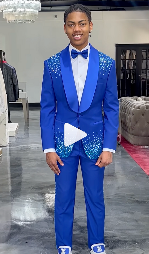 Person in blue suit with decorative details in a stylish indoor room