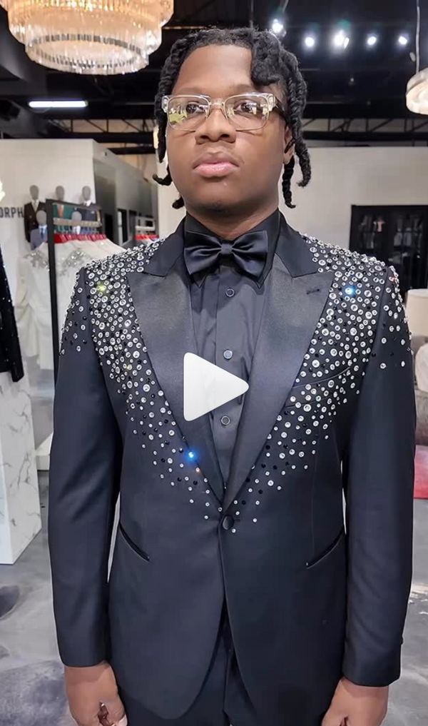 Black tuxedo with crystal embellishments worn in a sleek indoor setting