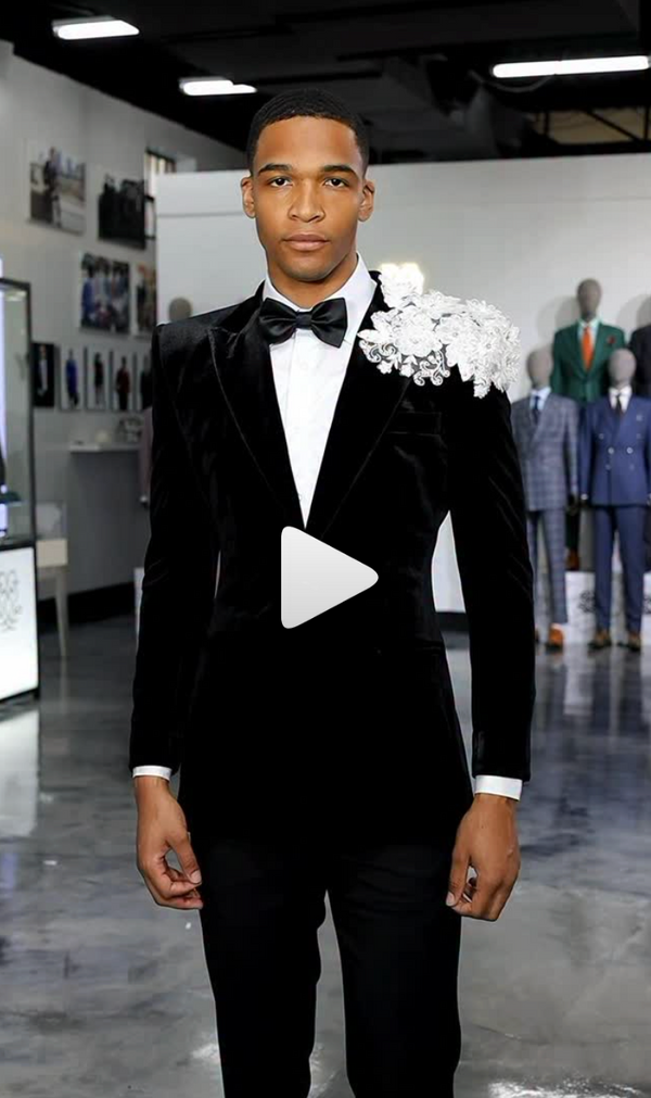 Black tuxedo with white boutonniere styled in a room with mannequins
