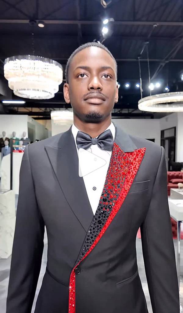 Black tuxedo with red sequin design in chandelier-lit elegant interior