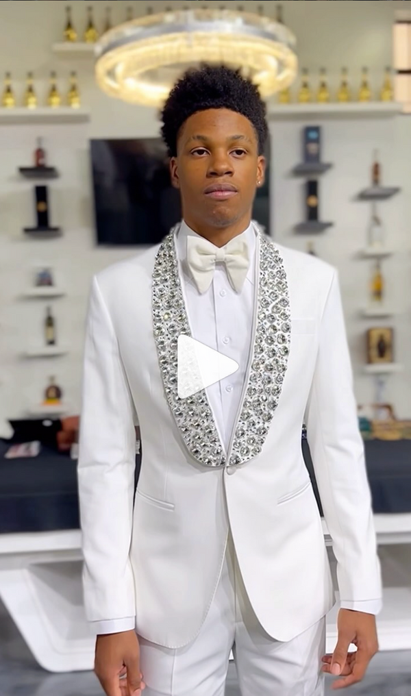 Well-dressed man in white suit and bow tie in a clean, minimalist setting
