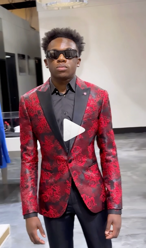Young man in red floral suit with sunglasses in sleek modern room