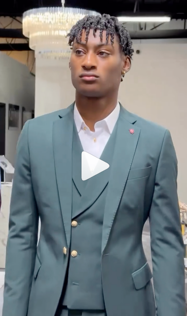 Stylish man wearing gray suit, white shirt, and gold buttons indoors